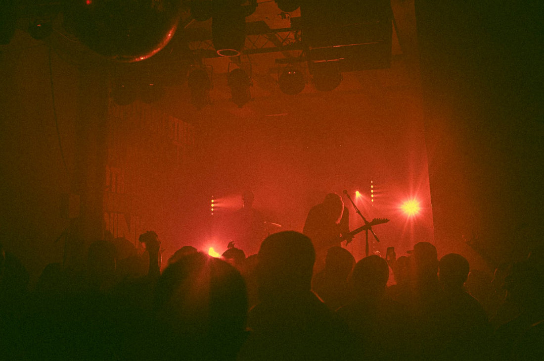 Band playing on a club stage in front of a crowd