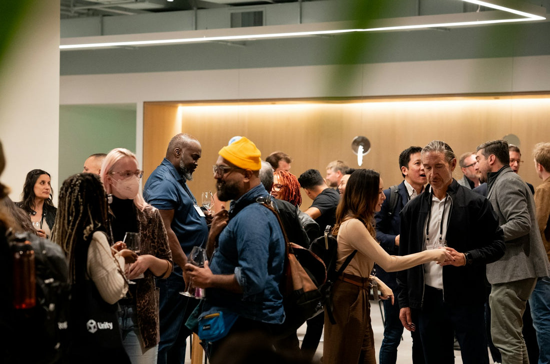 People chatting and mingling at a warmly lit indoor event